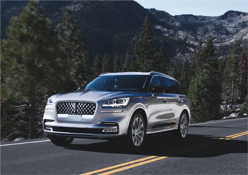 A 2023 Lincoln Aviator® Grand Touring SUV being driven on a winding road to demonstrate the capabilities of all-wheel drive | Mark McLarty Lincoln in North Little Rock AR