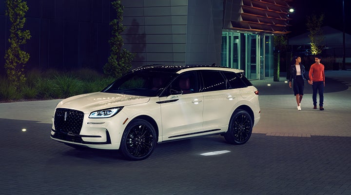 Two people approach a 2024 Lincoln Corsair® SUV featuring the available Jet Appearance Package. | Mark McLarty Lincoln in North Little Rock AR