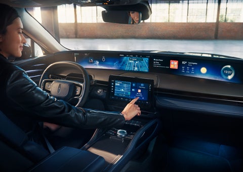 The driver of a 2024 Lincoln Nautilus® SUV interacts with the center touchscreen. | Mark McLarty Lincoln in North Little Rock AR