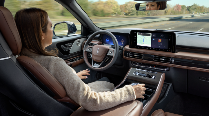 A woman is seen sitting in the driver’s seat of her 2025 Lincoln Aviator® SUV with her hands off the steering wheel. | Mark McLarty Lincoln in North Little Rock AR
