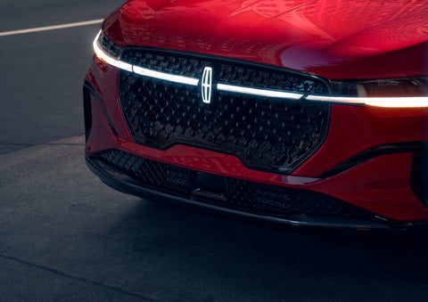 The available front LED light bar and center Lincoln Star logo glow at dusk. | Mark McLarty Lincoln in North Little Rock AR