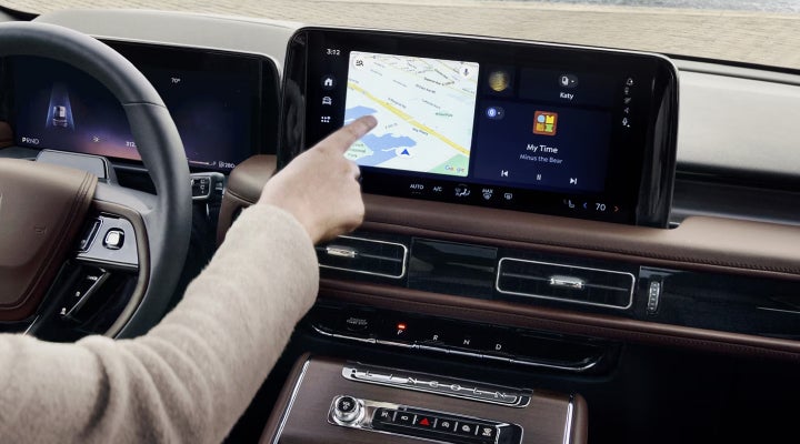 A person is tapping the center display touchscreen of a 2026 Lincoln Aviator® SUV. | Mark McLarty Lincoln in North Little Rock AR