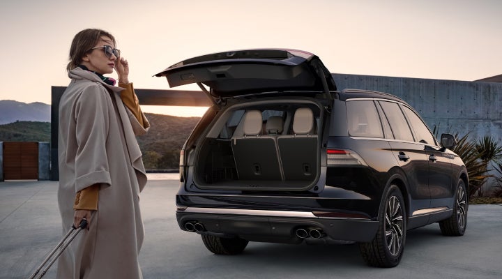 A woman approaches a 2026 Lincoln Aviator® SUV with its rear liftgate open. | Mark McLarty Lincoln in North Little Rock AR