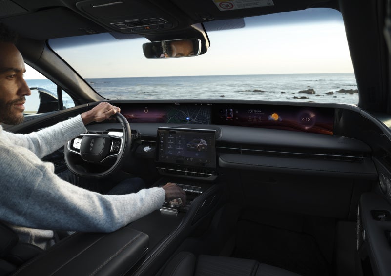 A driver of a parked 2026 Lincoln Nautilus® SUV takes a relaxing moment at a seaside overlook while inside his Nautilus. | Mark McLarty Lincoln in North Little Rock AR