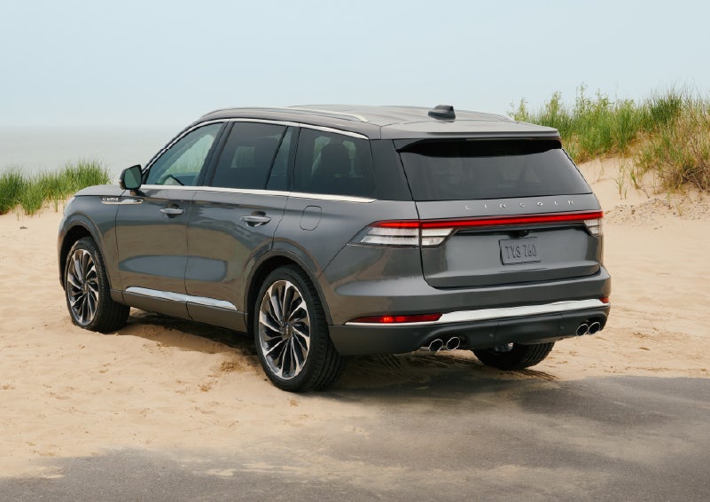 A 2027 Lincoln Aviator® SUV is parked next to sand dunes. | McLarty Lincoln in North Little Rock AR