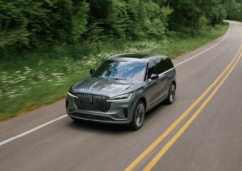 A 2027 Lincoln Aviator® SUV is being driven down a road. | McLarty Lincoln in North Little Rock AR