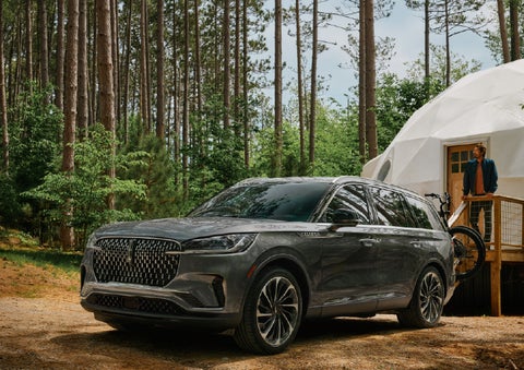 A 2027 Lincoln Aviator® is parked next to a high end glamping site. | McLarty Lincoln in North Little Rock AR