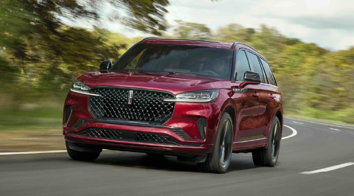 A 2027 Lincoln Aviator® SUV is being driven on a country road | McLarty Lincoln in North Little Rock AR