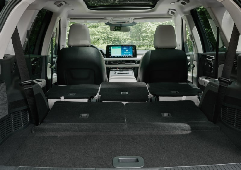 A rear to front view of the interior of a 2027 Lincoln Aviator® Black Label™ SUV shows the third and second rows folded flat | McLarty Lincoln in North Little Rock AR