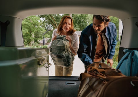 A couple loads luggage into the rear of a 2027 Lincoln Aviator® Black Label™ SUV..e 202 | McLarty Lincoln in North Little Rock AR