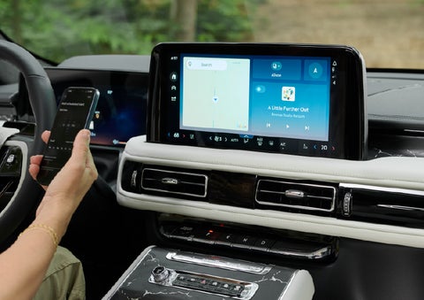 A person pairs thier phone with the center touchscreen of a 2027 Lincoln Aviator® Black Label™ SUV | McLarty Lincoln in North Little Rock AR